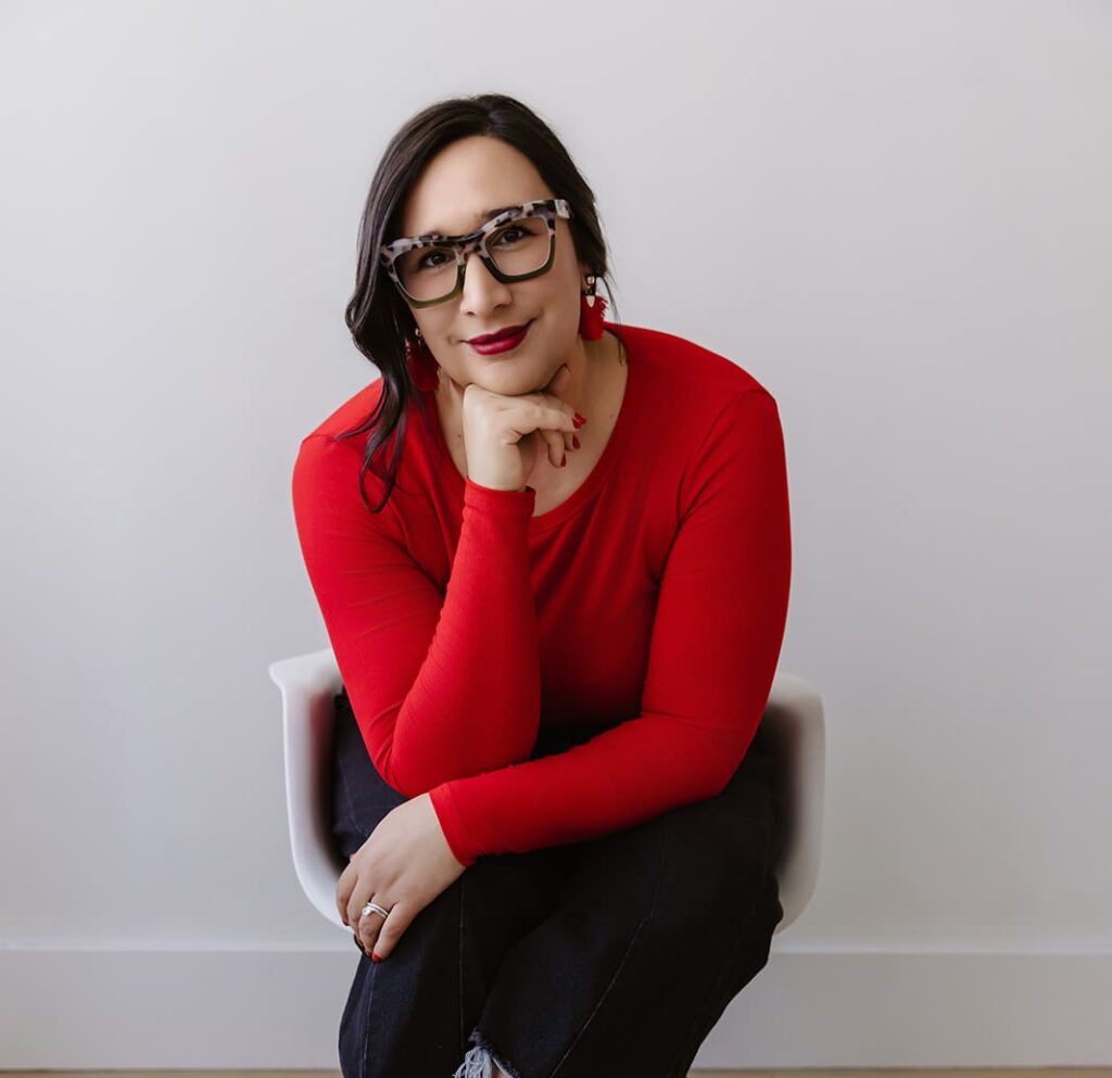 Personal brand session with woman sitting on chair in natural light studio located in Cedar Rapids, Iowa.